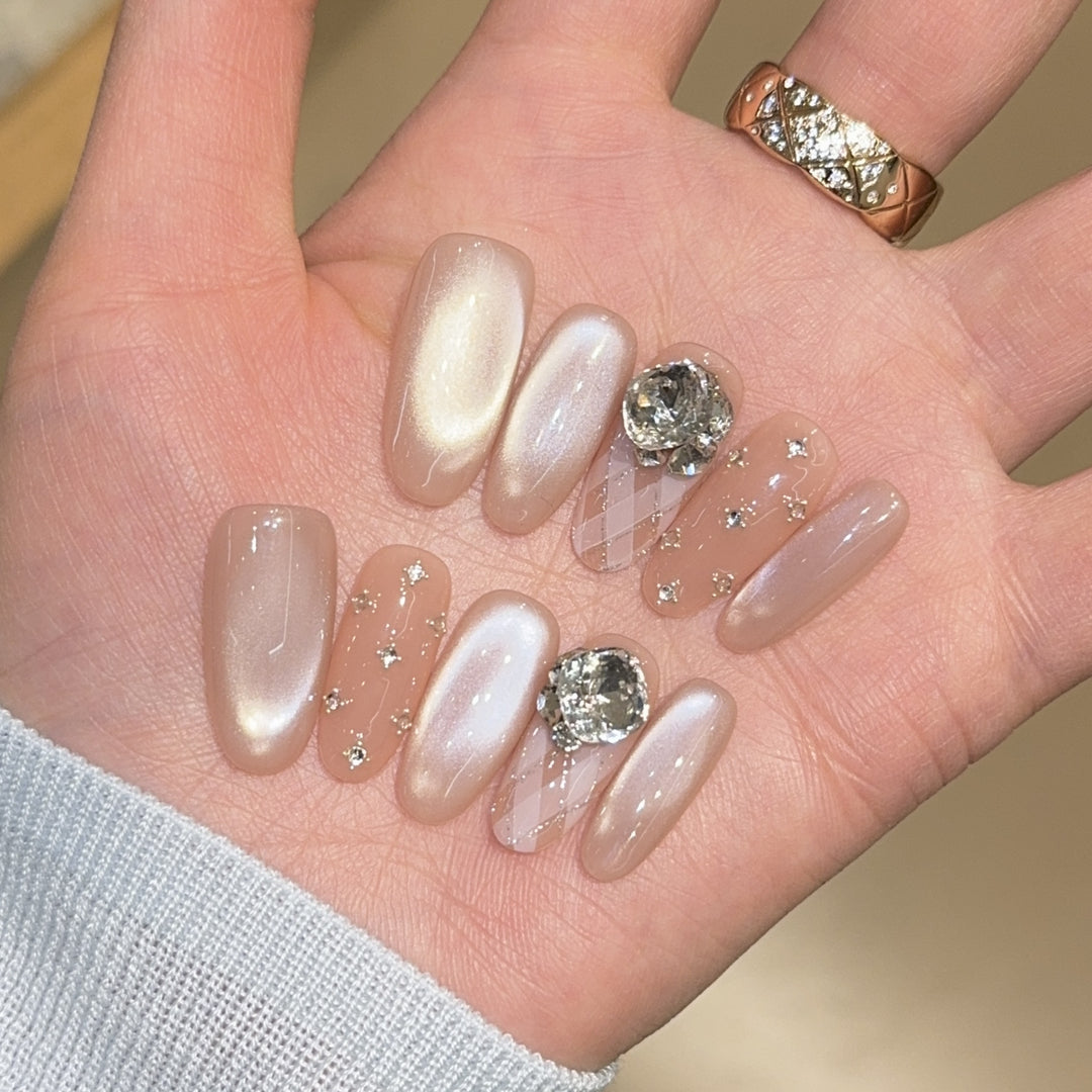 Elegant artificial nails with shimmering effects and rhinestone accents Stornfield
