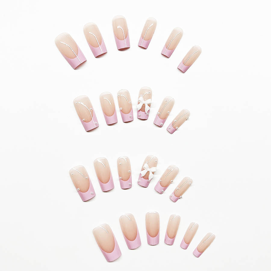 Artificial nail set with romantic bow and pearl embellishments Stornfield