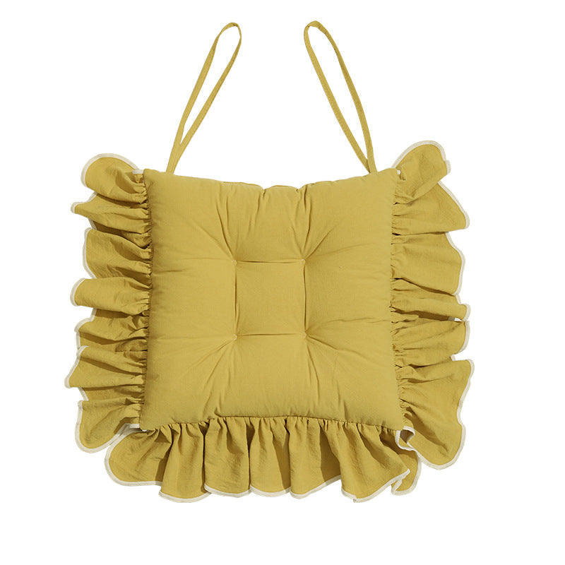 Padded chair cushion with ruffle and fastening bands