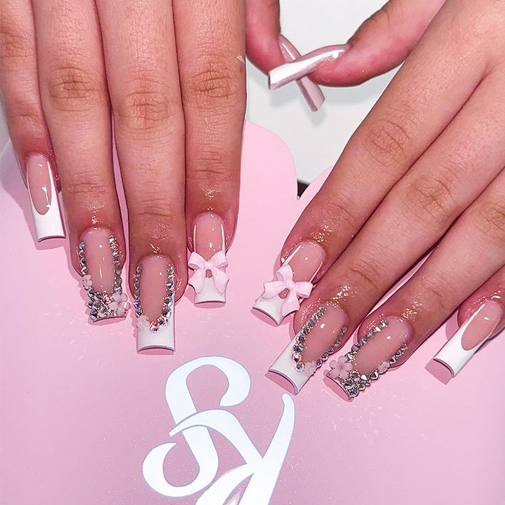 Artificial nail set with careful ribbon and glitter decorations Stornfield