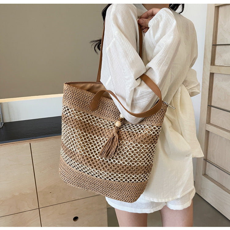 Handbag made of woven natural material with playful tassel detail Stornfield