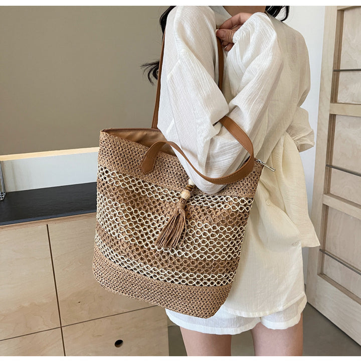 Handbag made of woven natural material with playful tassel detail Stornfield
