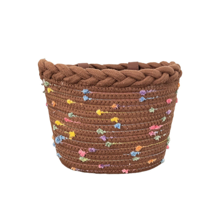 braided rope bike basket with pom pom embellishments and leather handlebar straps Stornfield