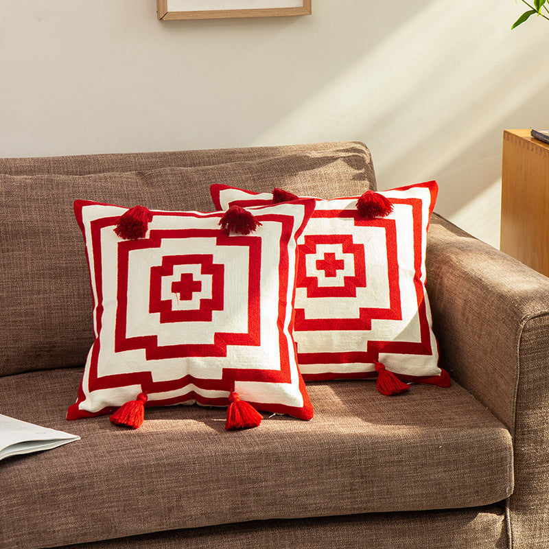 Square cushion cover in graphic geometric relief with decorative tassels
