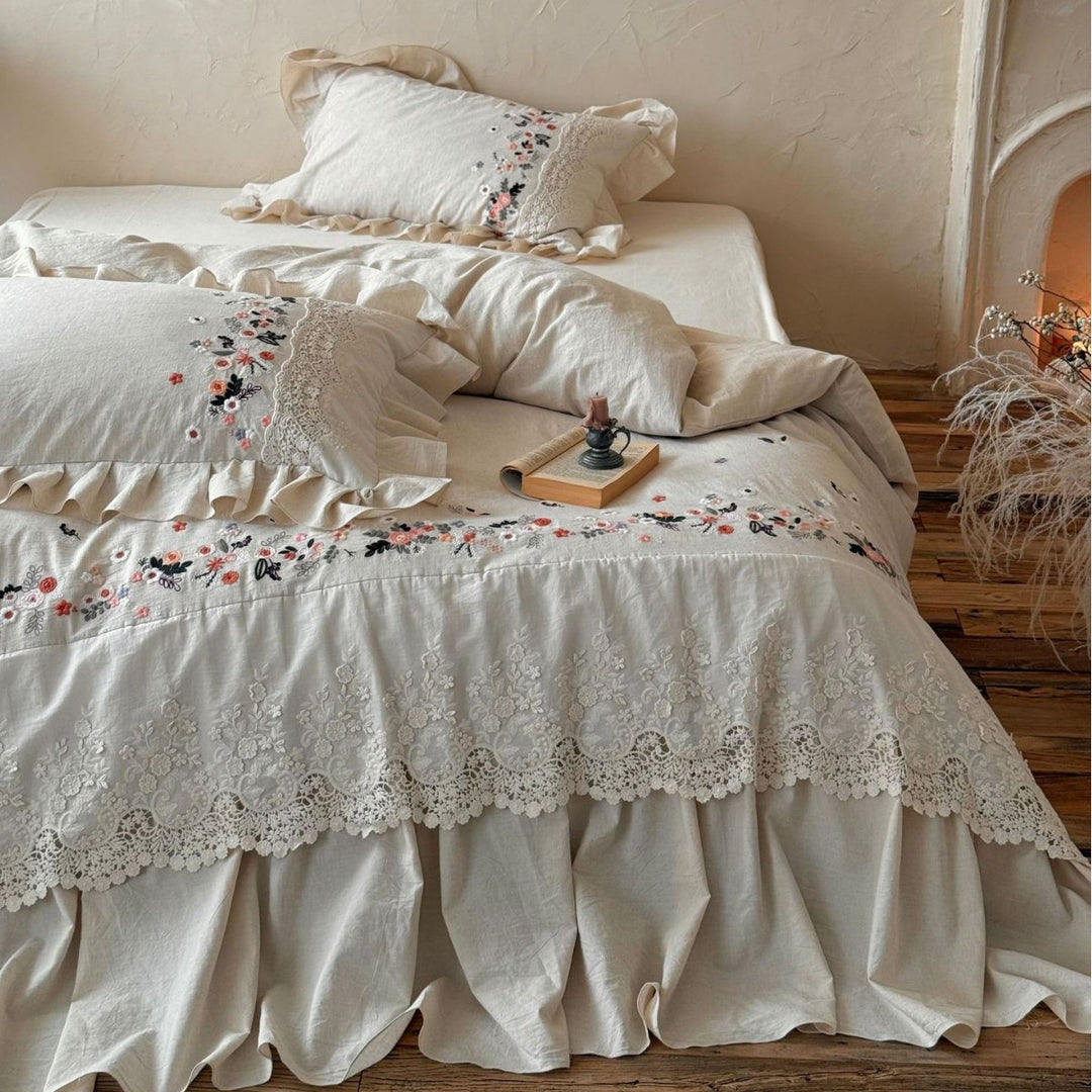 Romantic bedding set in country house style with embroidered border, frill and lace appliqué