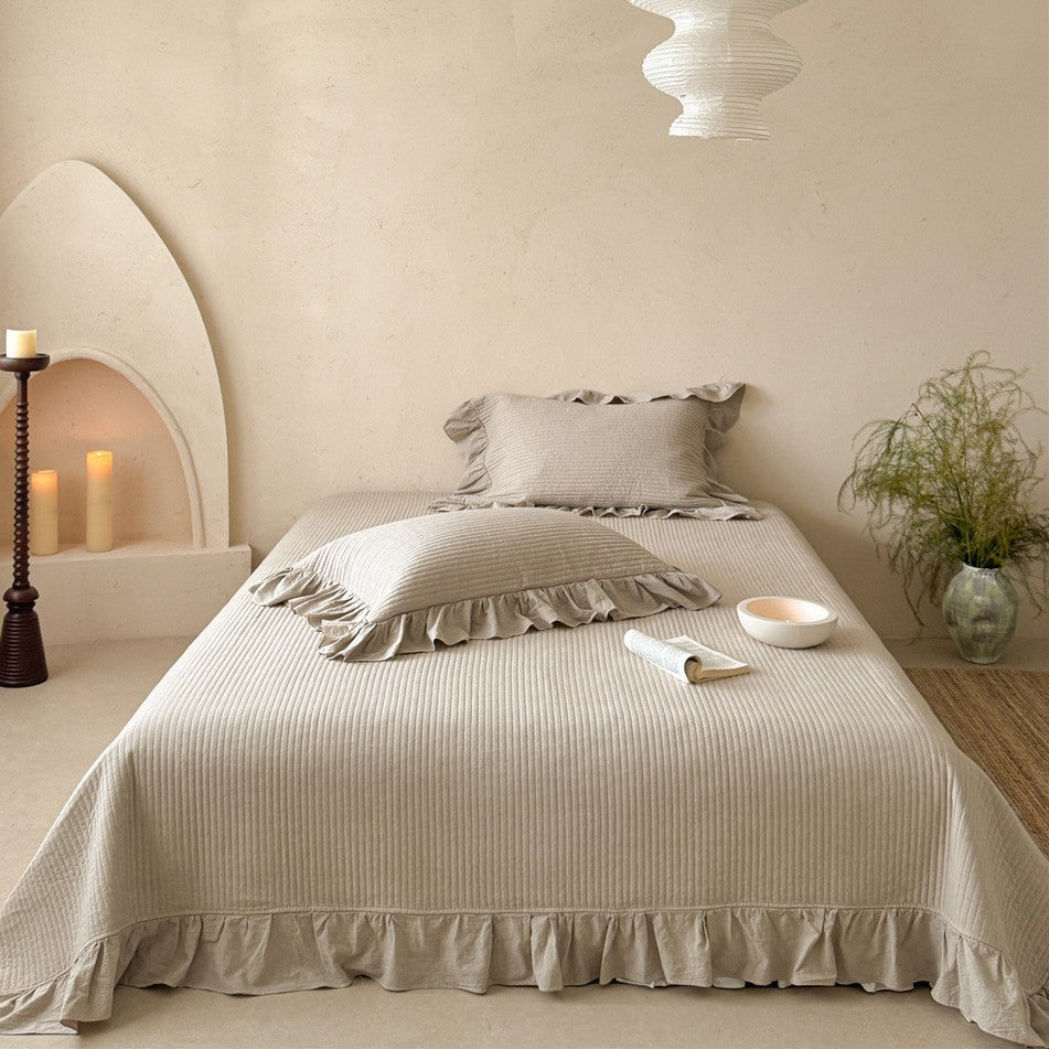 Luxurious quilted cotton bedding set with ruffles and embroidered details