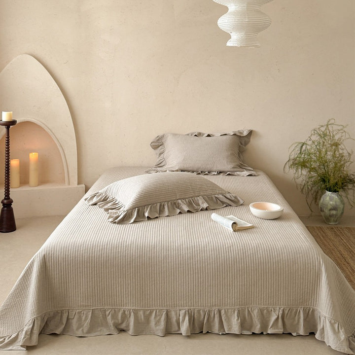 Luxurious quilted cotton bedding set with ruffles and embroidered details