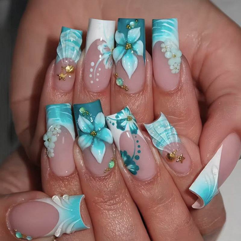 Acrylic nail set with elegant floral decorations and glitter accents Stornfield