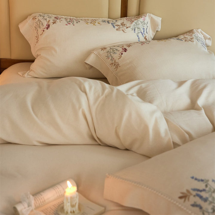 Romantic cotton satin duvet cover set with delicate floral embroidery and decorative pillow