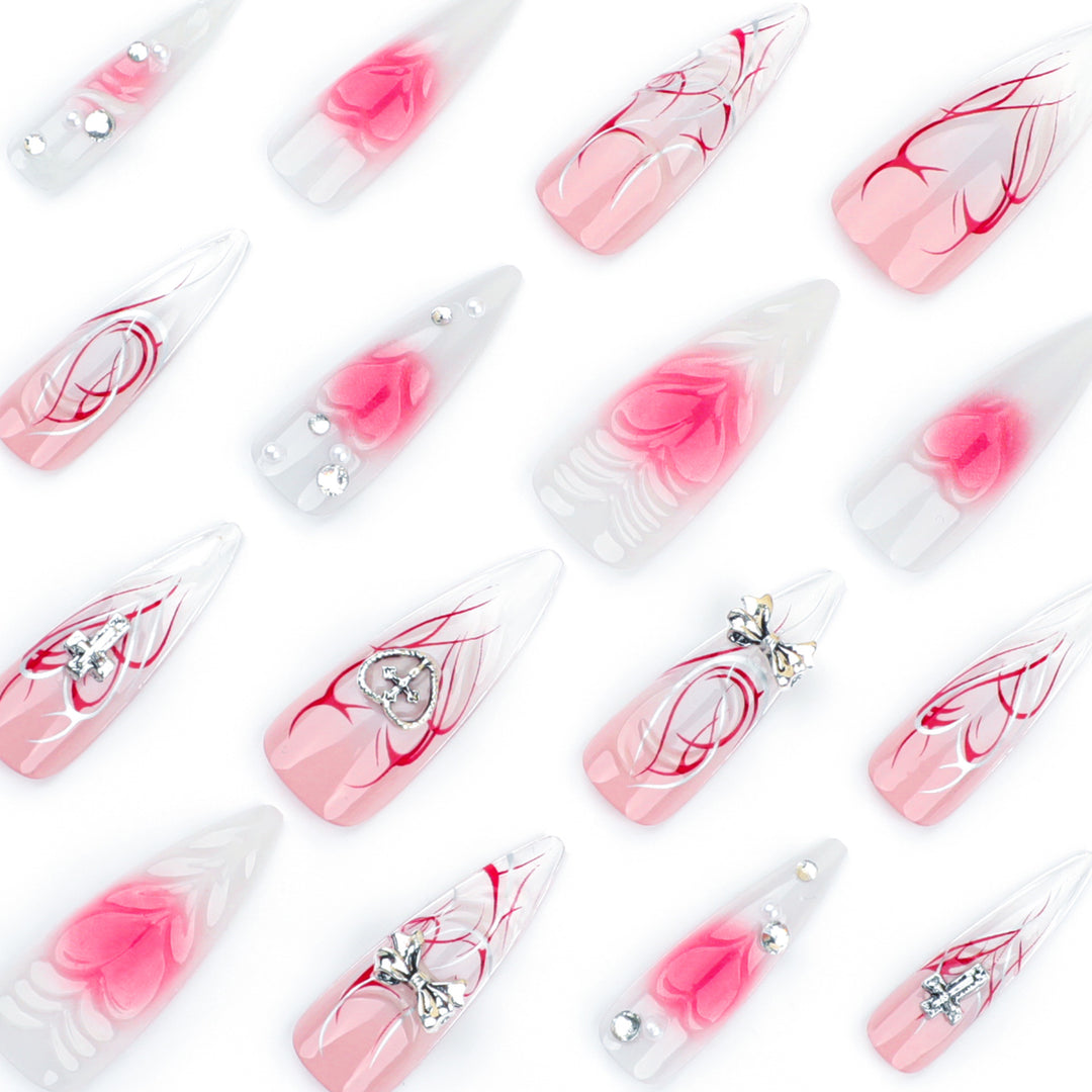 Artful stiletto nails with elegant floral accents and glitter embellishments Stornfield