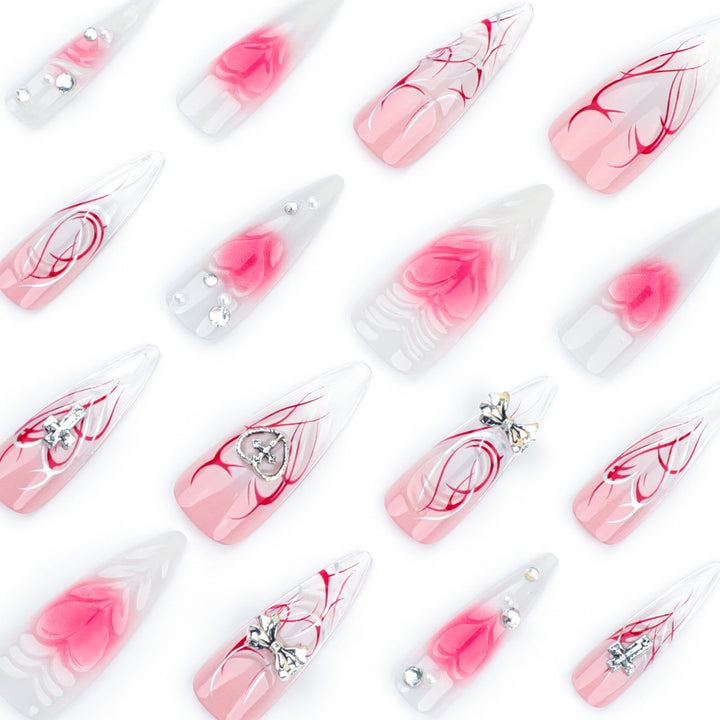 Artful stiletto nails with elegant floral accents and glitter embellishments Stornfield