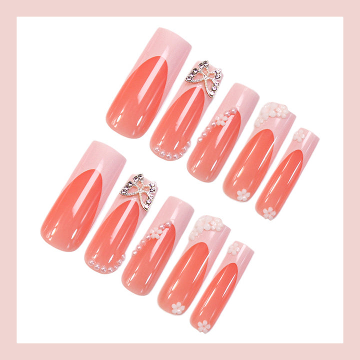 Artificial nail set with elegant floral decorations and glitter accents Stornfield