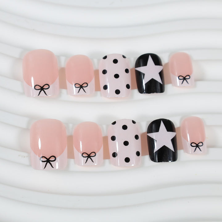 Acrylic nail set with playful dots and star motifs Stornfield