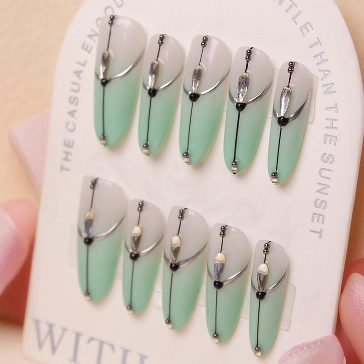 Acrylic nail set with elegant ombre effect and glamorous embellishments Stornfield