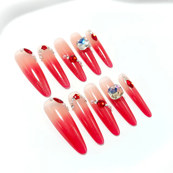 Artificial nails in elegant ombre style with glitter and jewelry accents Stornfield