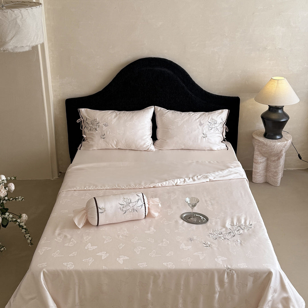 Light jacquard satin bed linen set with embroidered butterfly motif and decorative roll Stornfield