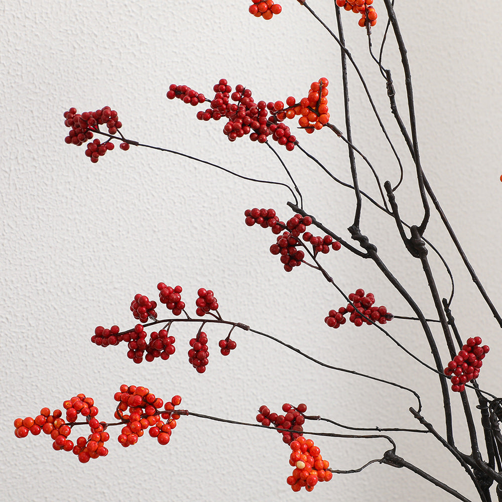 Decorative artificial flower branch with glowing red berries