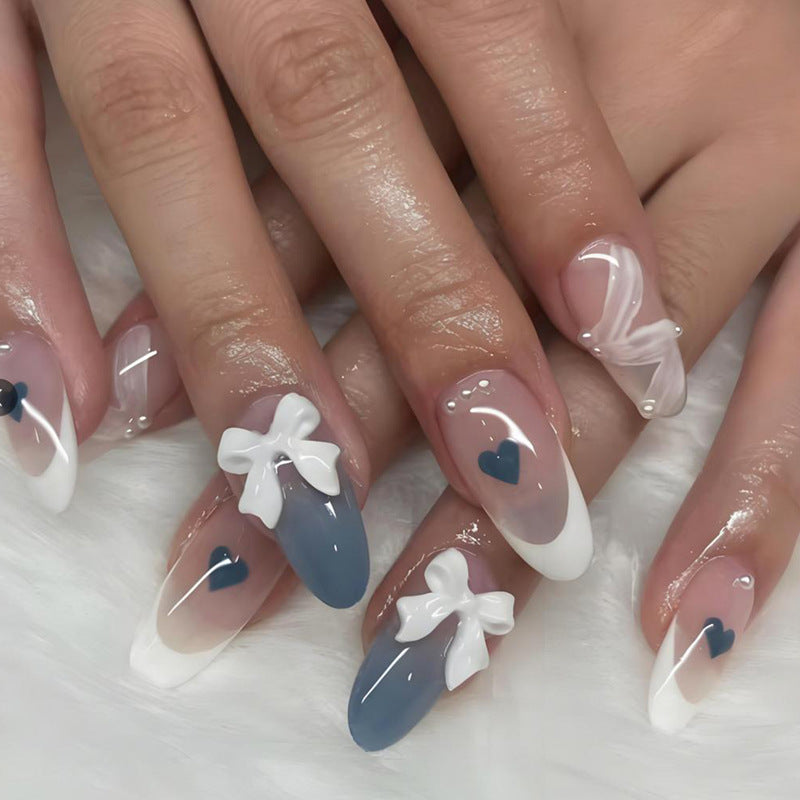 Artificial nail set with elegant bows and heart-shaped accents Stornfield