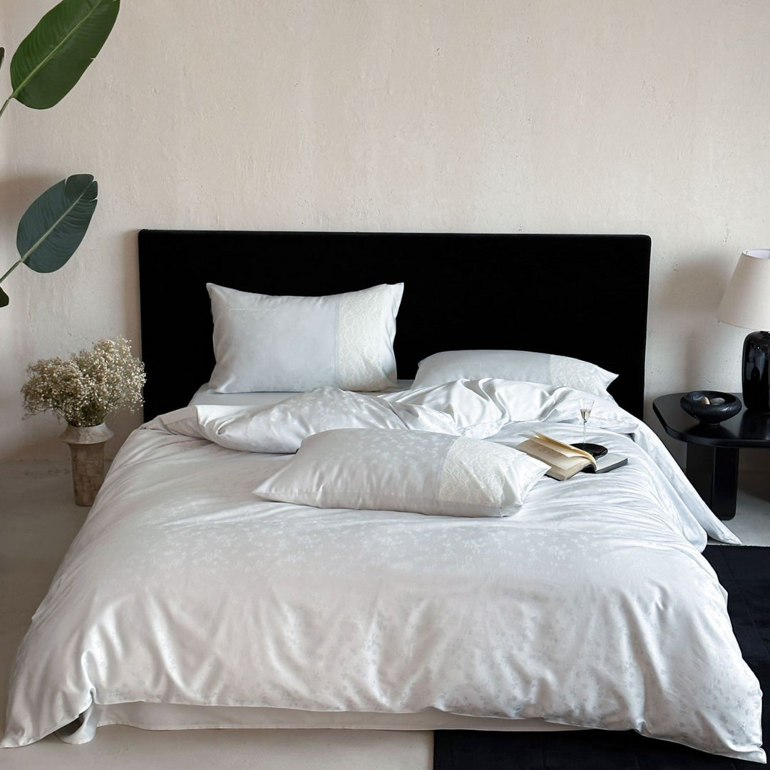 Satin bed set with subtle floral jacquard, reversible look and elegant piping seam