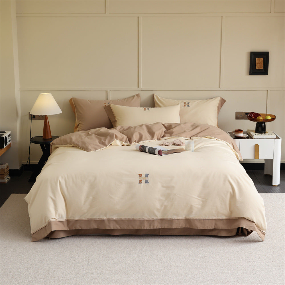 Luxurious cotton satin bedding set with contrasting piped edge and monogram embroidery