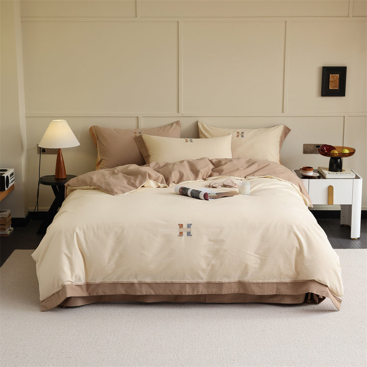 Luxurious cotton satin bedding set with contrasting piped edge and monogram embroidery