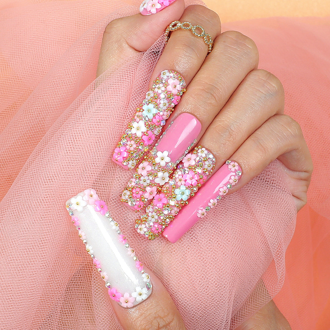 Artificial nail set with floral decorations and glitter accents Stornfield