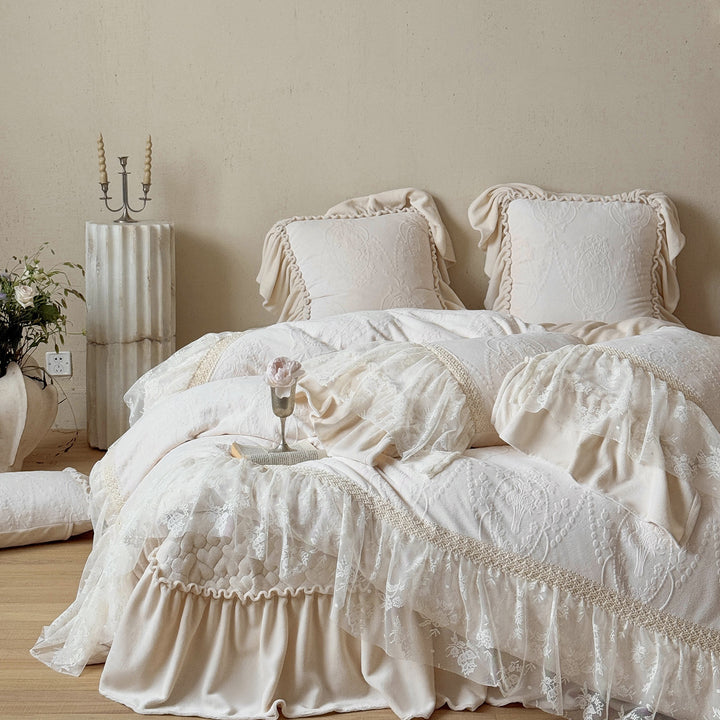 Romantic bedding set with lace trim, ruffle, and quilted blanket