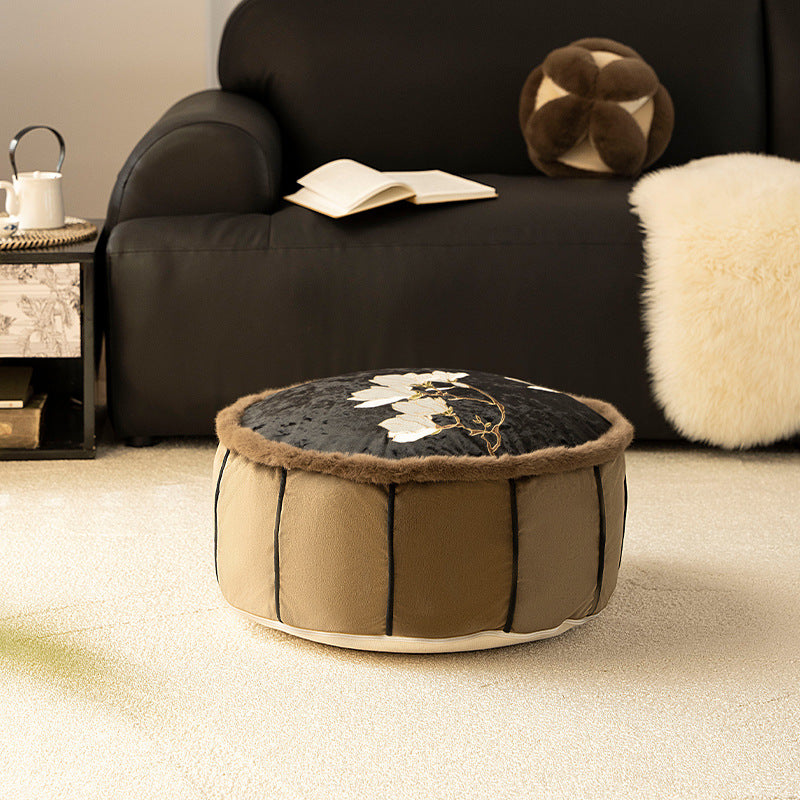 Round upholstered velvet floor cushion pouf with faux fur trim and handle Stornfield