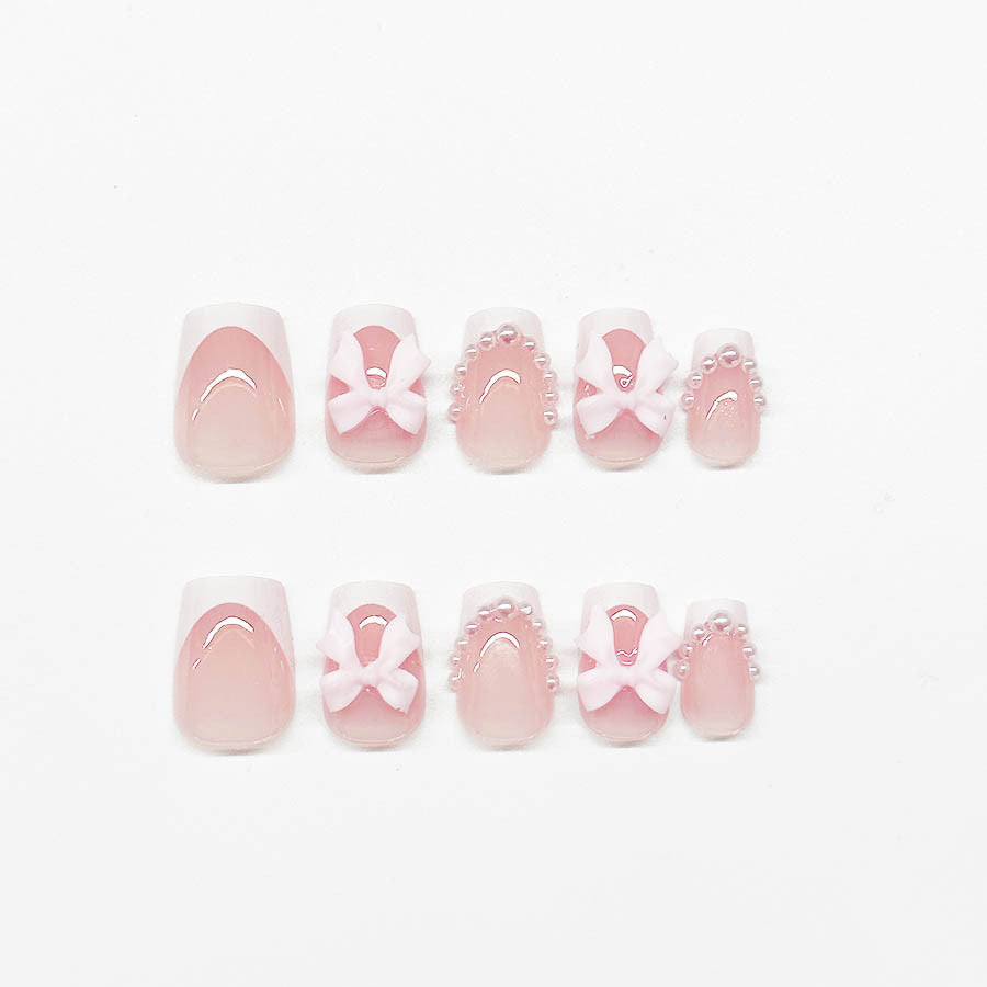 Artificial nails with elegant bows and pearl embellishments Stornfield