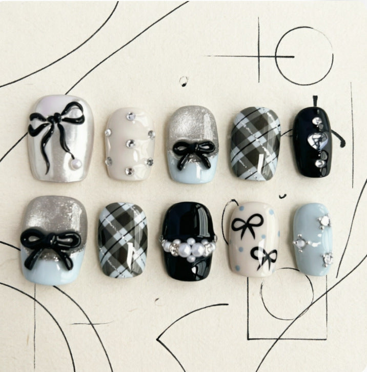 Artificial nails with elegant bows and rhinestones Stornfield