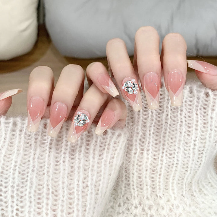 Artificial nail set with filigree tip designs and glamorous rhinestone accents Stornfield