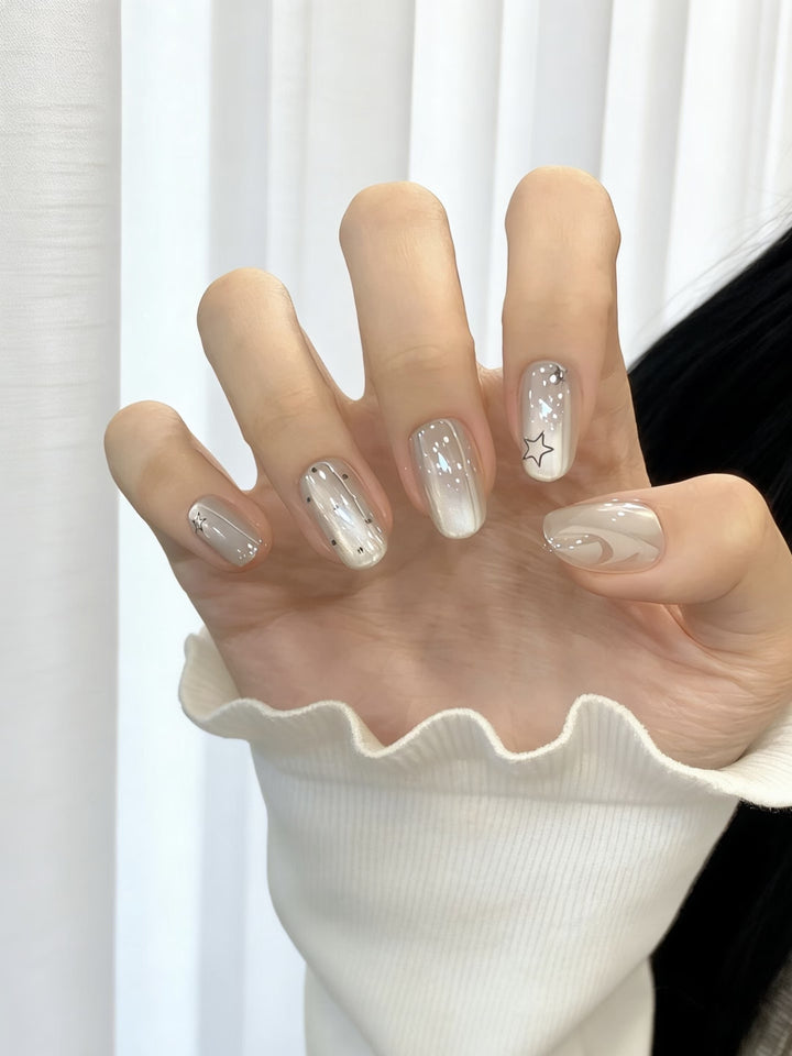Artistic Press-On Nail Set featuring Celestial and Abstract Patterns