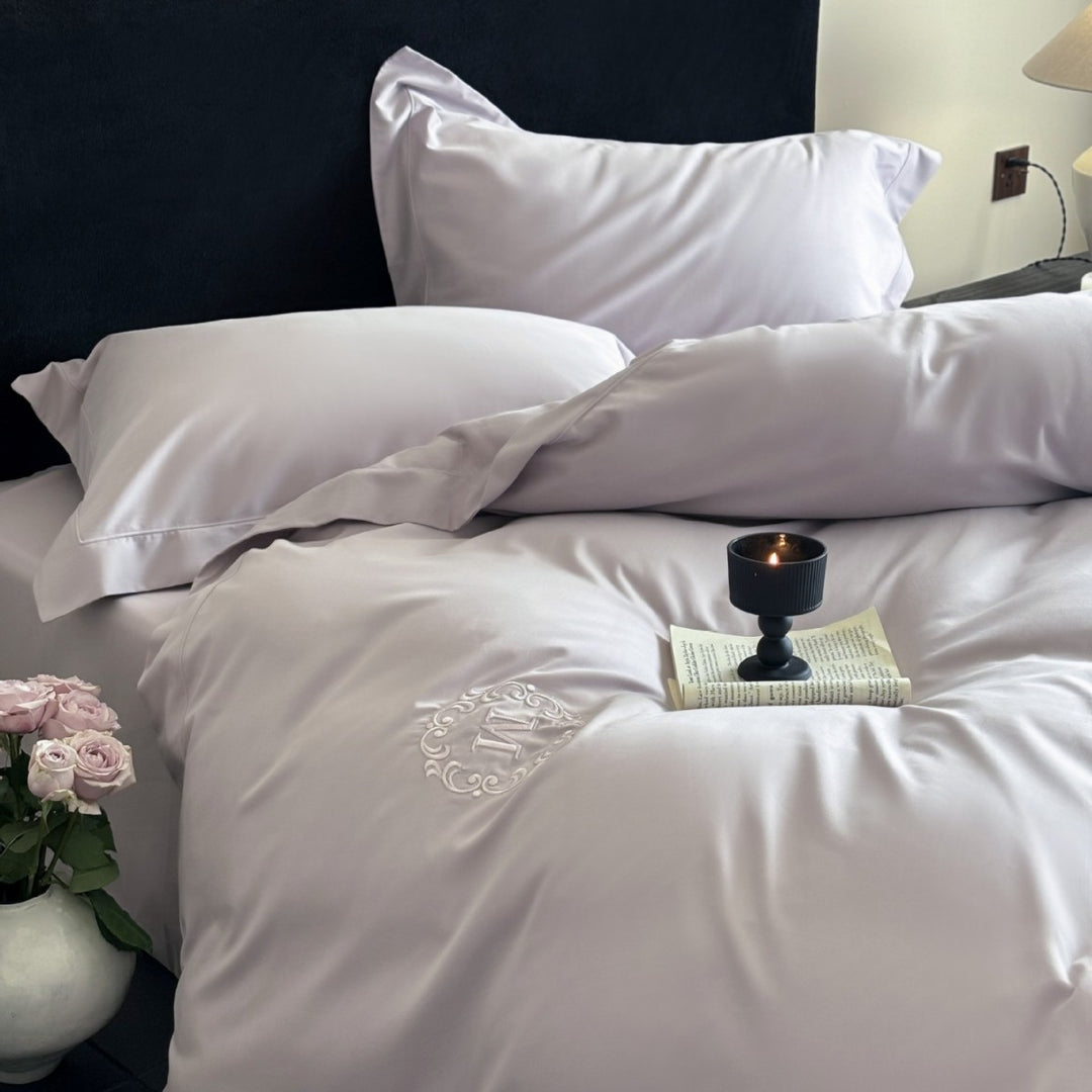Luxurious cotton satin bedding set with monogram embroidery and fine piping