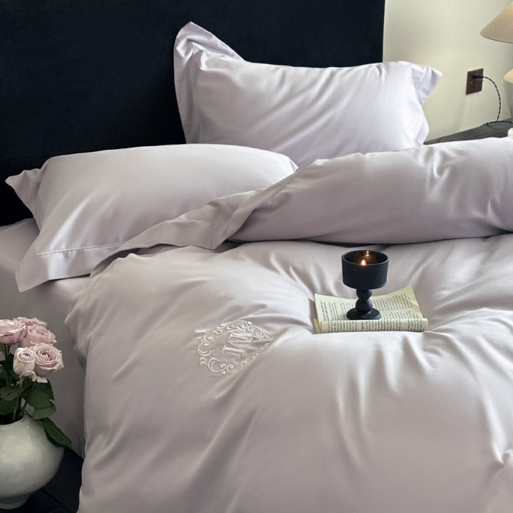 Luxurious cotton satin bedding set with monogram embroidery and fine piping