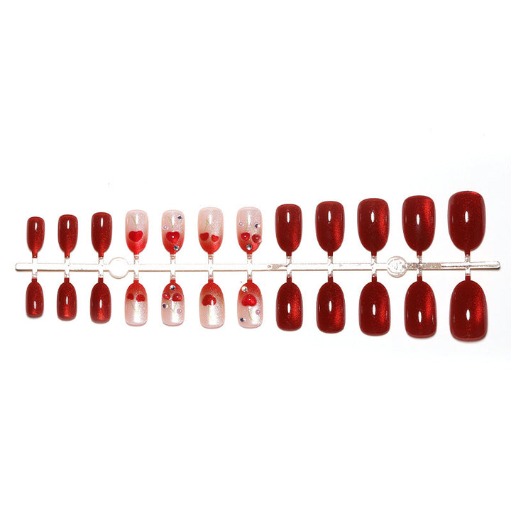 Artificial nail set with glamorous accents and creative heart motifs Stornfield