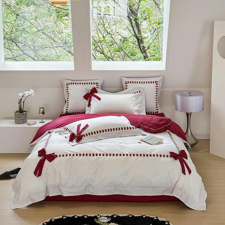 Reversible cotton satin bedding set with decorative bow appliqués