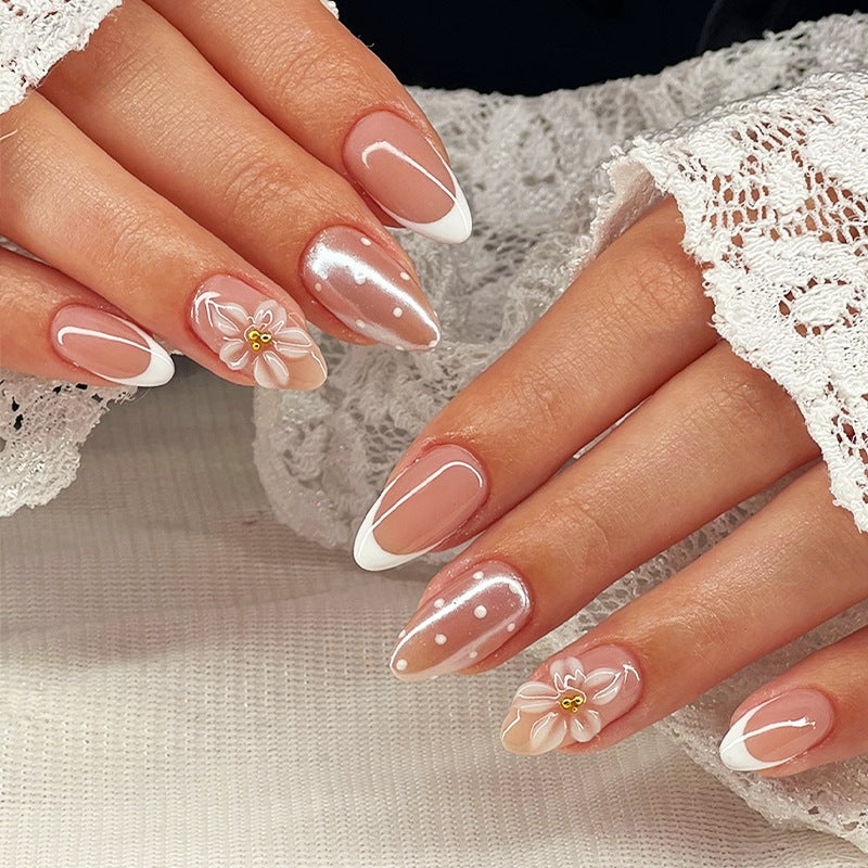 Artificial nail set with elegant French tips and delicate floral accents Stornfield