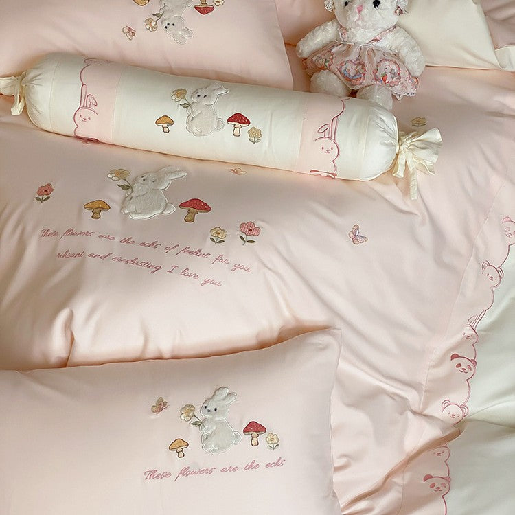Playful cotton bedding set with plush bunny appliqué and round cushion