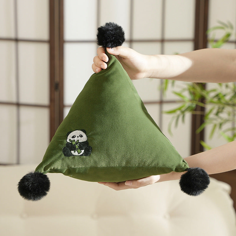 Pyramid-shaped triangle cushion with faux fur pom-poms and zebra embroidery