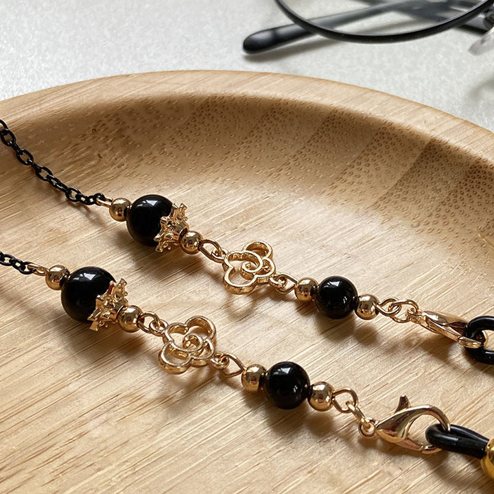 Filigree glasses chain holder with pearls and golden accents Stornfield
