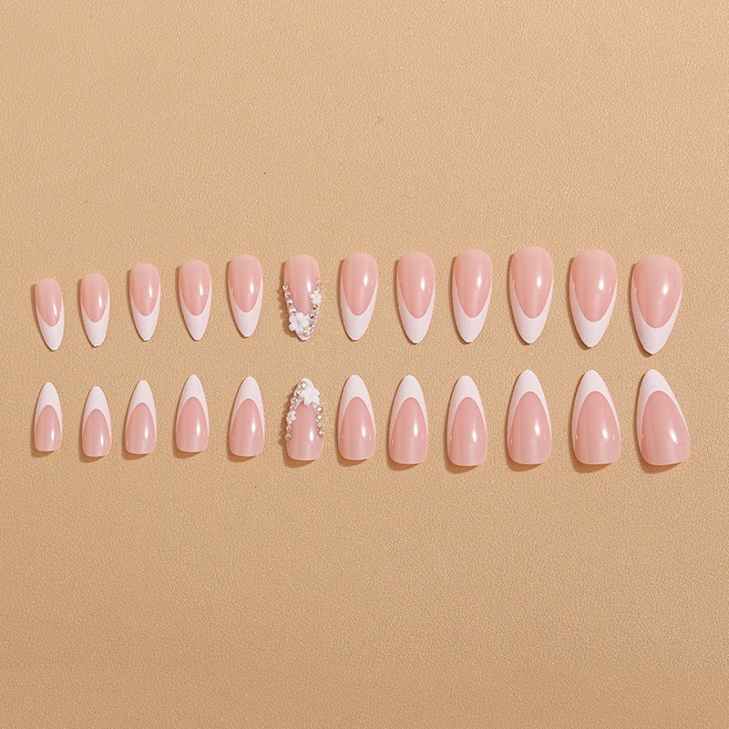 Artificial nails with elegant French tips and rhinestone details Stornfield