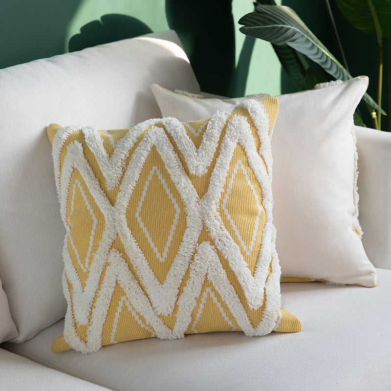 Decorative cushion cover with hand-tufted diamond relief and soft bouclé application