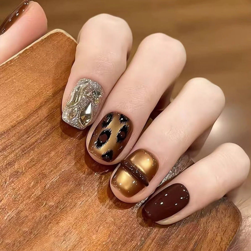 Glamorous artificial nails with animal design and glitter accents Stornfield