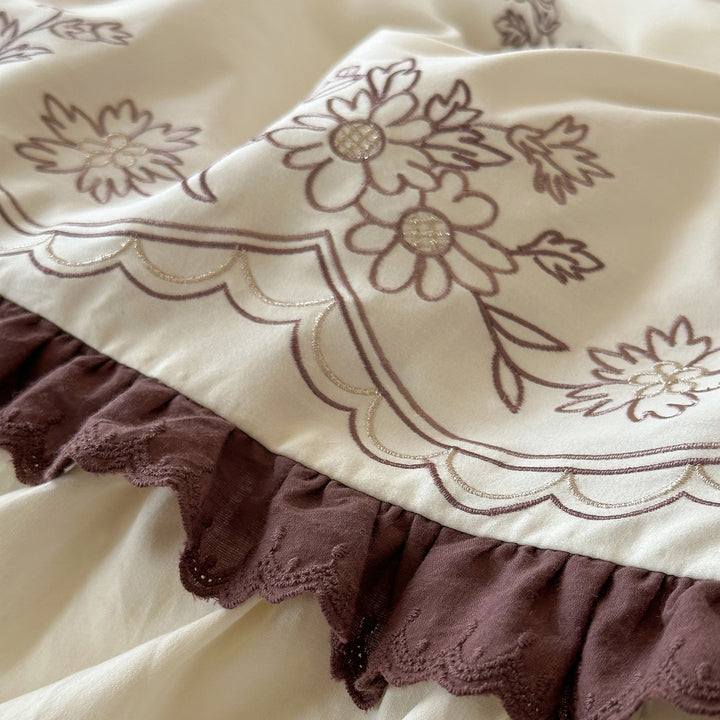 Luxurious bedding set with embroidered cover, ruffled bed skirt, and decorative pillow