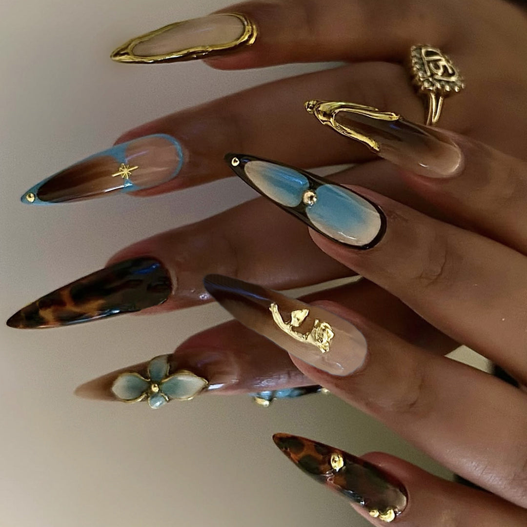 Artificial nail set with luxurious gold design and floral accents Stornfield