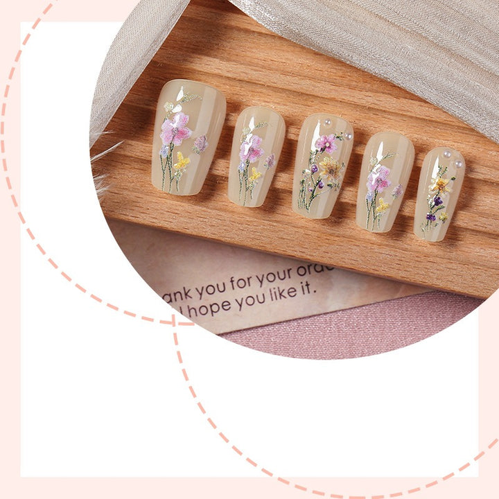 Artificial nail set with floral embellishments and glamorous details Stornfield