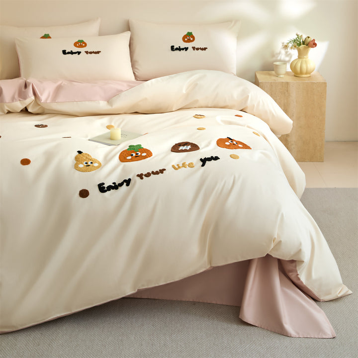 Embroidered bedding set with cute pumpkin appliqués and reversible functionality
