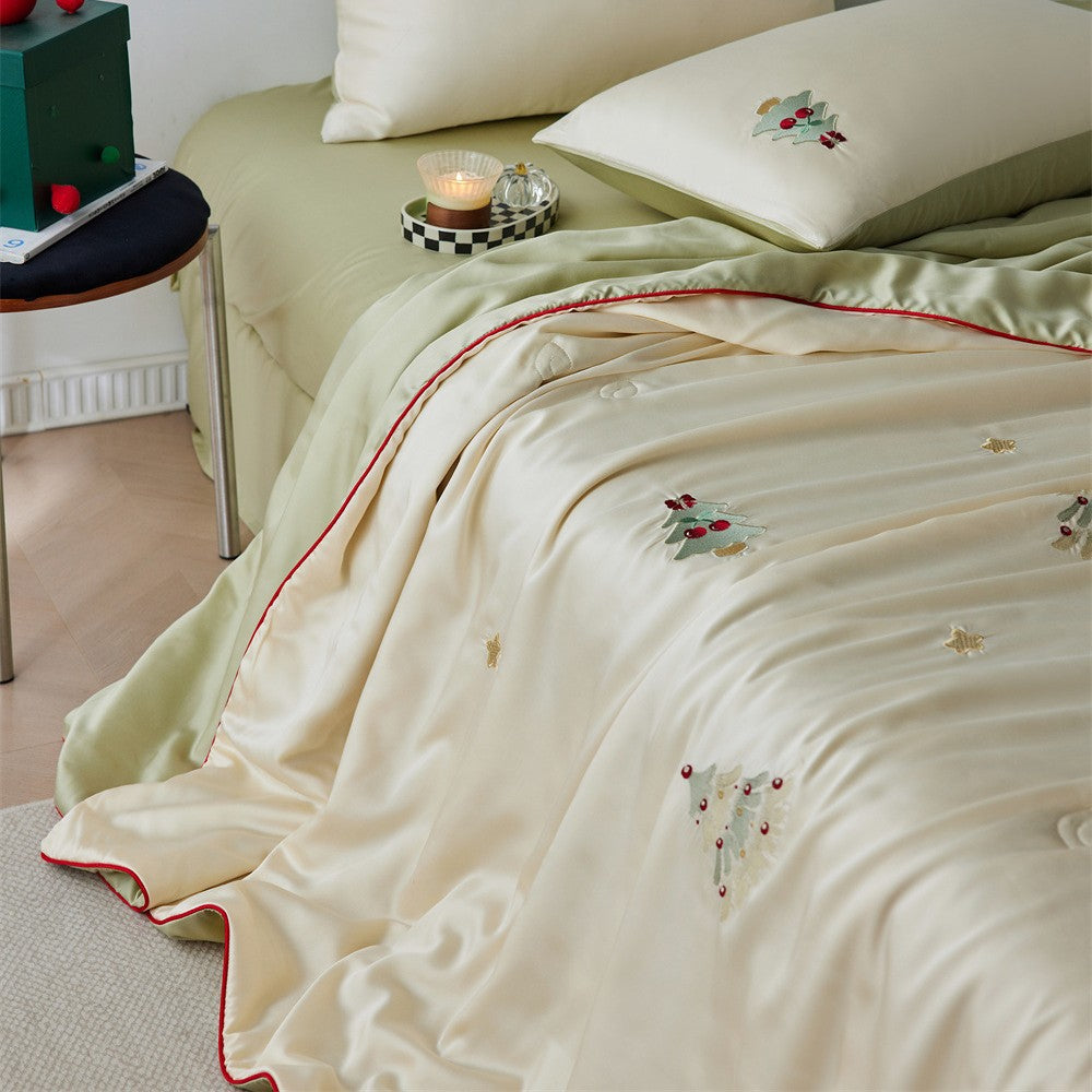 Luxurious satin bed linen set with embroidered Christmas tree motifs and contrasting piping