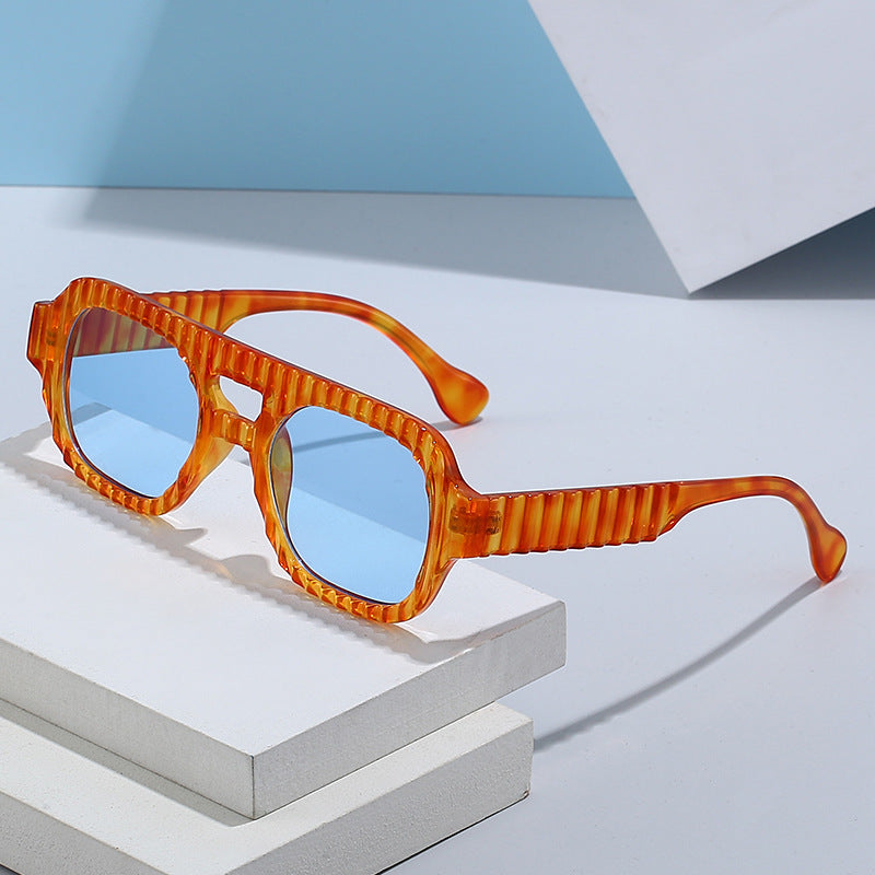 Ladies fashionable sunglasses in futuristic design with textured frame Stornfield