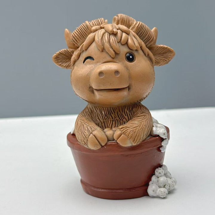 Funny decorative figure of a Highland cow on toilet Stornfield